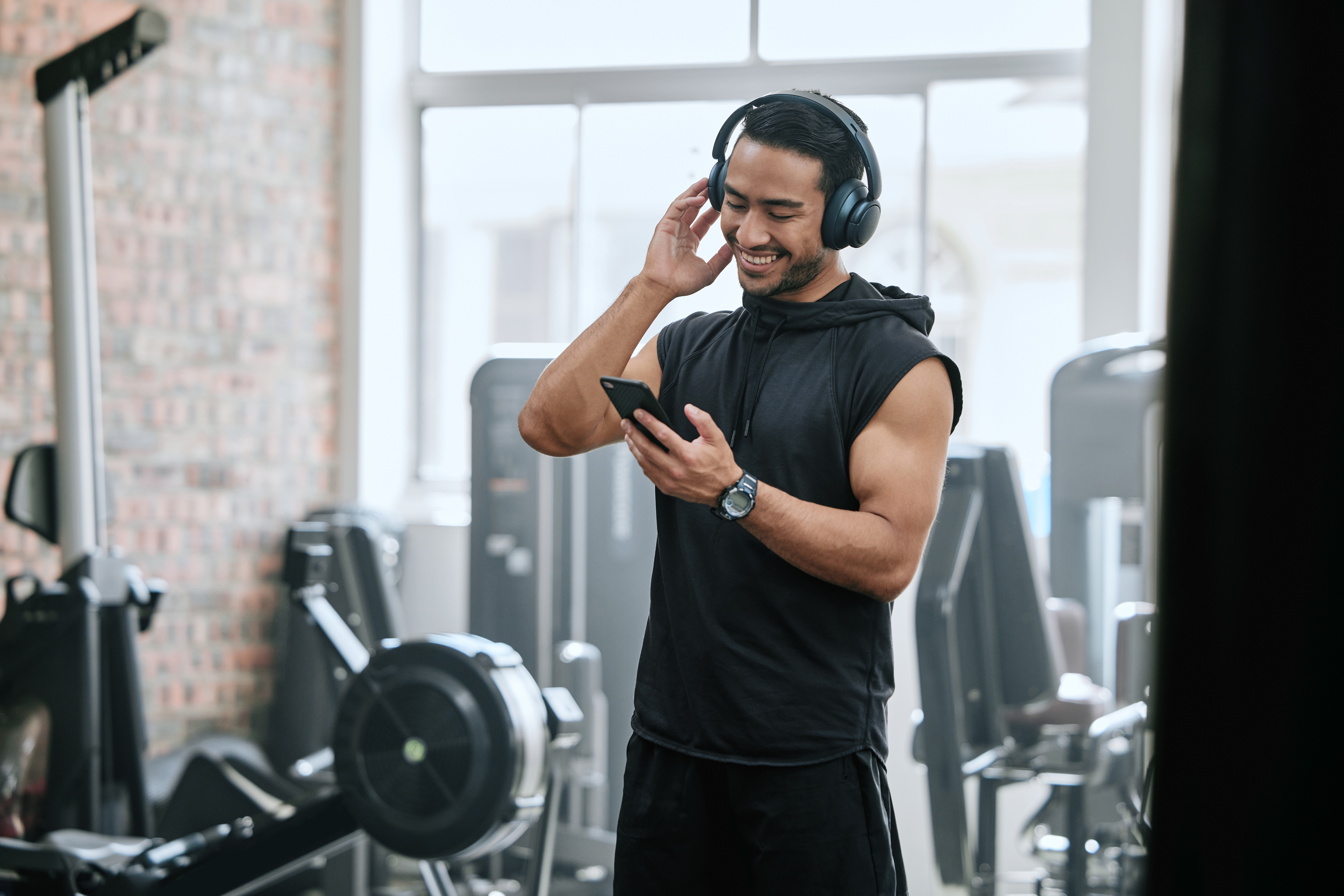 Listening,,Headphones,And,Man,With,Cellphone,In,Gym,,Athlete,And